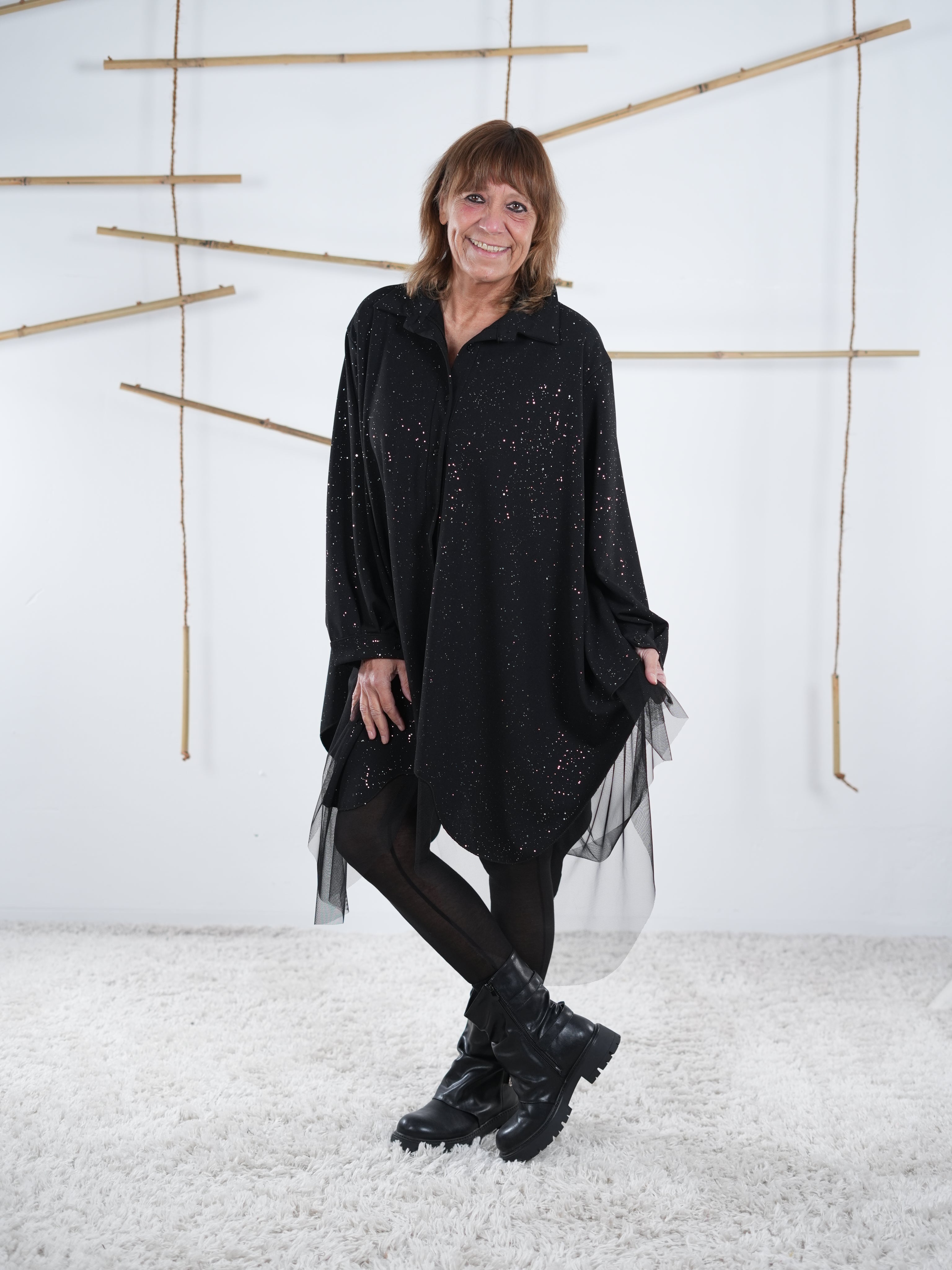 Frontansicht der schwarzen Tunika mit Glitzer und Tüll. Fokus liegt auf den Verzierungen aus Tüll.